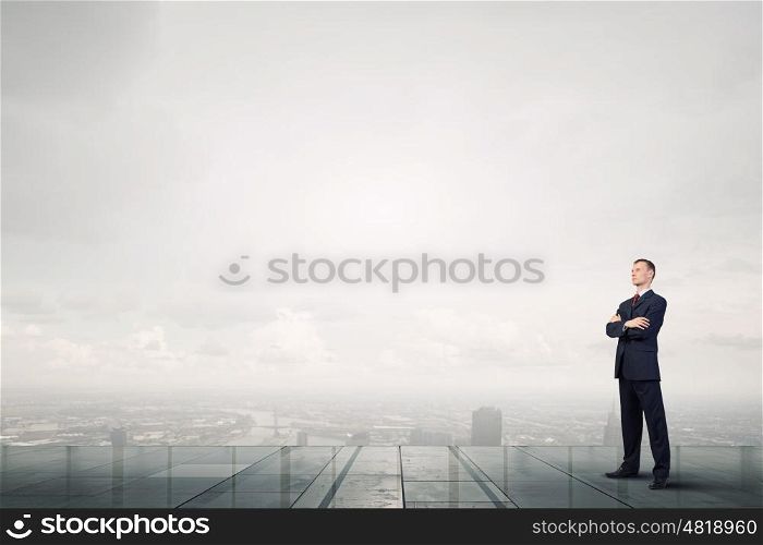 Determined in his business. Confident businessman with his arms crossed on chest