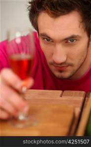 Determined man looking at a wine glass