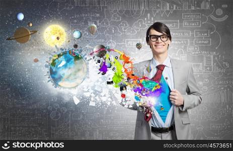 Determined super businessman . Young smiling businessman acting like super hero and tearing his shirt off. Elements of this image are furnished by NASA