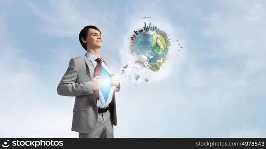 Determined super businessman . Young smiling businessman acting like super hero and tearing his shirt off. Elements of this image are furnished by NASA