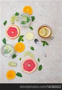 detox beverage concept: the and infused water with lime,grapefruit,citrus,lemon and mint on marble background
