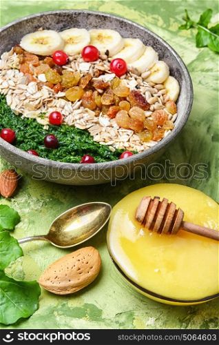 detox breakfast of oatmeal.buddha bowls. concept of healthy diet of oatmeal,banana,raisins and spinach