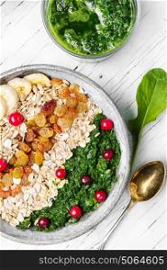 detox breakfast of oatmeal.buddha bowls. concept of healthy diet of oatmeal,banana,raisins and spinach