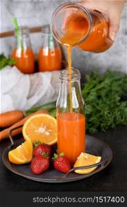 Detox drink. Freshly made Carrot Strawberry Orange Juice. For those who monitor their health