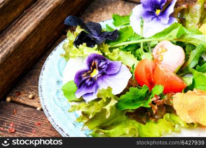 Detox flowers salad. Fresh summer salad with edible flowers and herbs.Healthy food