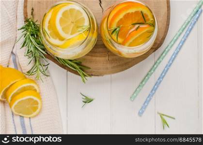 Detox fruit infused flavored water. Refreshing summer homemade cocktail with lemon and orange