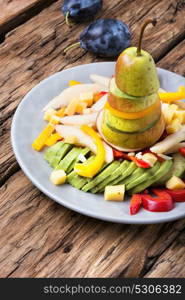 detox salad with summer fruits. Vegetarian unusual salad with pear, avocado, plum, berries and pepper