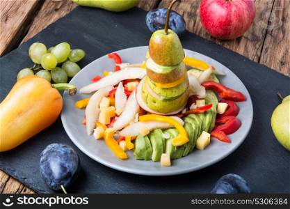 detox salad with summer fruits. Vegetarian unusual salad with pear, avocado, plum, berries and pepper