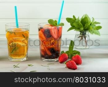 Detox water cocktails on wooden table.