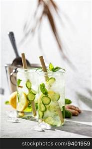 Detox water with lemon, cucumber and mint, summer drink, homemade lemonade on summer light background