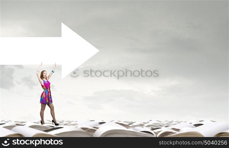 Develop your imagination. Woman in multicolored dress with arrow banner in hands