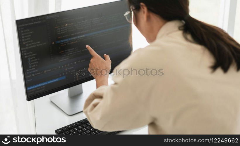 Developer programmer checking code on monitor while programming to developing web and application.