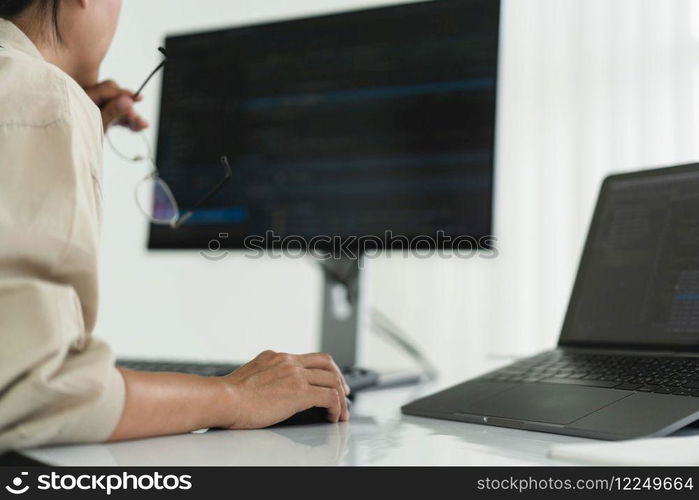 Developer programmer checking code on monitor while programming to developing web and application.