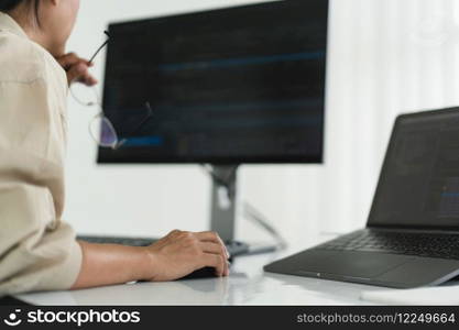 Developer programmer checking code on monitor while programming to developing web and application.
