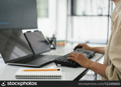 Developer programmer checking code on multiple monitor while programming to developing web and apps.