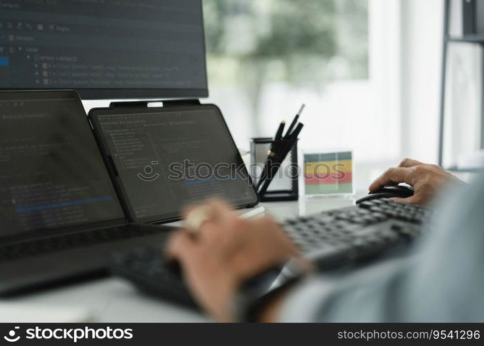 Developer programmer checking code on multiple monitor while programming to developing web and apps.