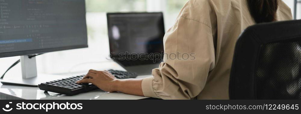 Developer programmer programming code to developing website and application in software office.