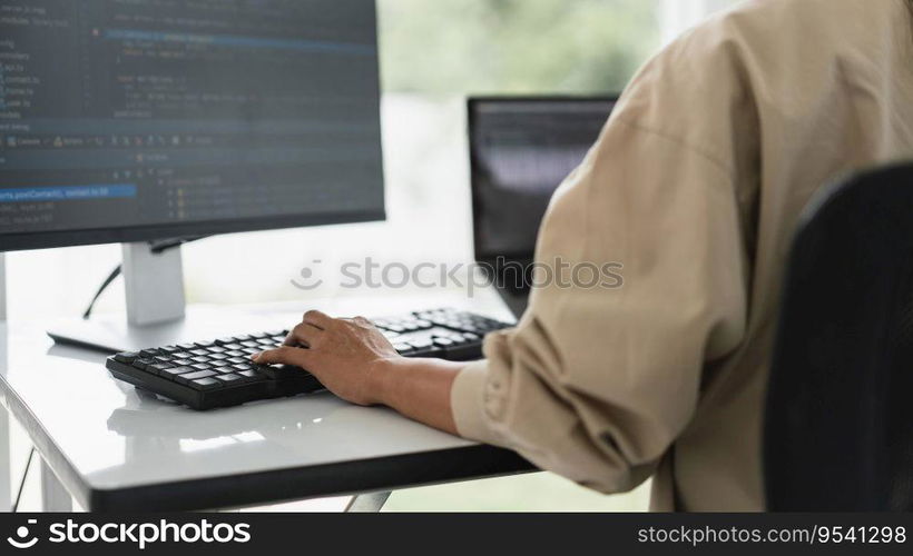 Developer programmer programming code to developing website and application in software office.