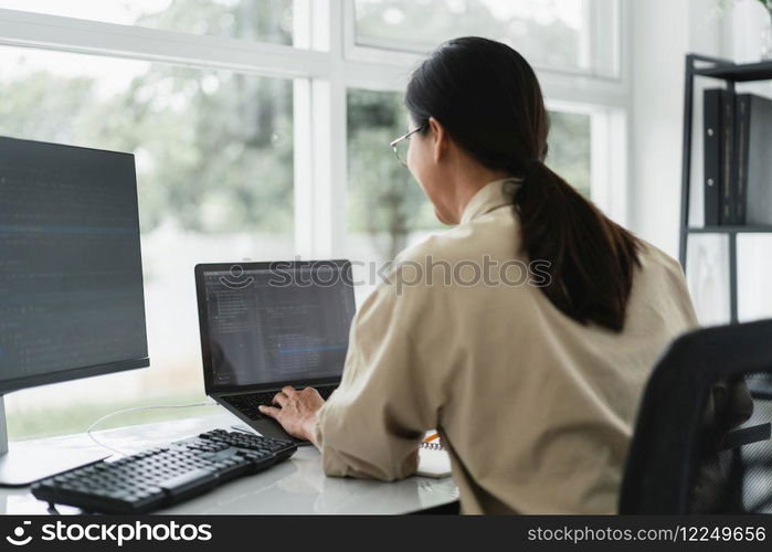 Developer programmer typing code on laptop while programming to developing website and application.