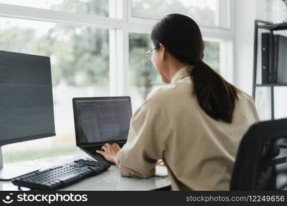 Developer programmer typing code on laptop while programming to developing website and application.