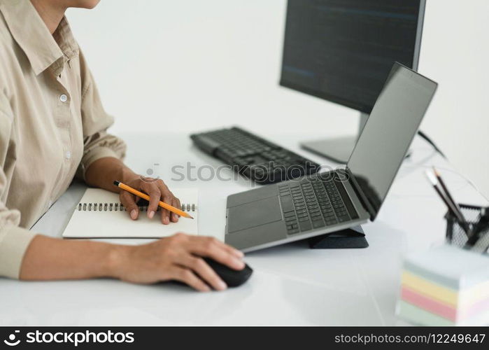 Developer programmer use mouse and checking code on laptop while programming to developing website.