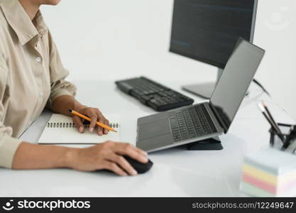 Developer programmer use mouse and checking code on laptop while programming to developing website.