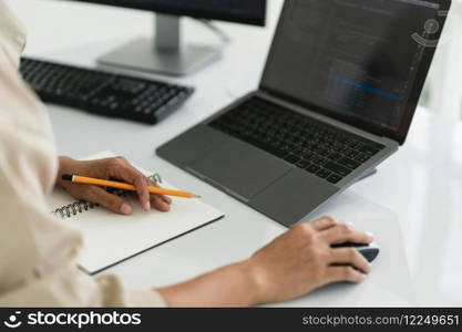 Developer programmer use mouse and checking code on laptop while programming to developing website.