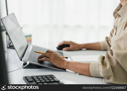 Developer programmer using mouse and typing code on laptop while programming to developing website.