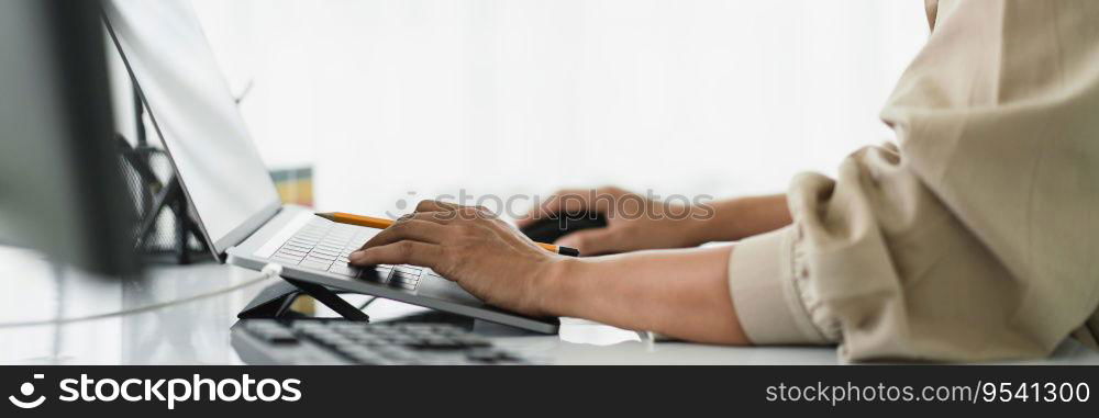 Developer programmer using mouse and typing code on laptop while programming to developing website.