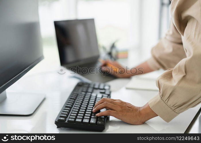 Developer programmer working on computer and laptop while programming code to developing website.