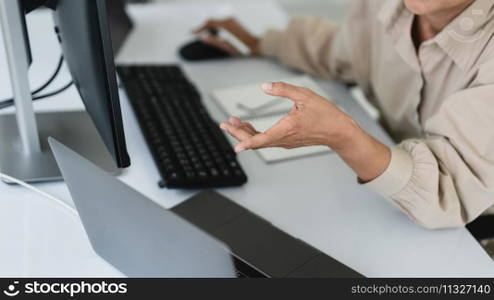 Developer programmer working to checking code on monitor while programming to developing website.
