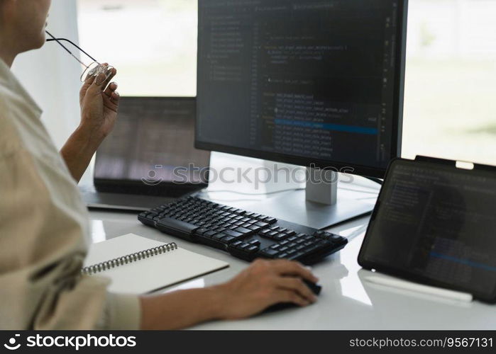 Developer programmer working to checking code on monitor while programming to developing website.