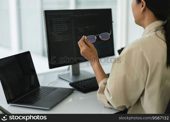 Developer programmer working to checking code on monitor while programming to developing website.