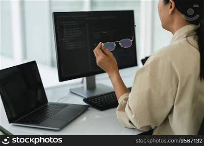 Developer programmer working to checking code on monitor while programming to developing website.