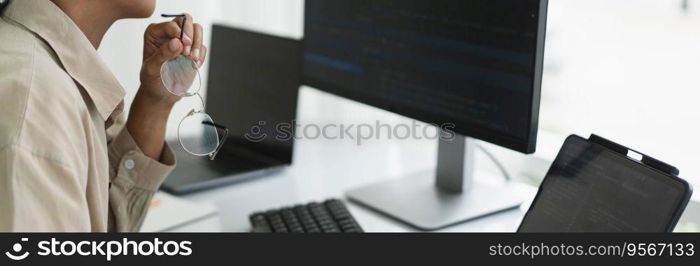Developer programmer working to checking code on monitor while programming to developing website.