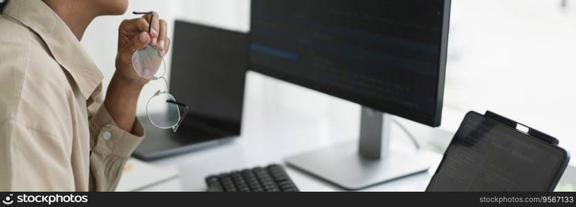 Developer programmer working to checking code on monitor while programming to developing website.