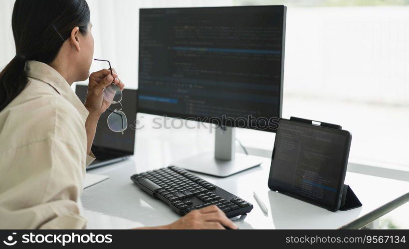 Developer programmer working to checking code on monitor while programming to developing website.