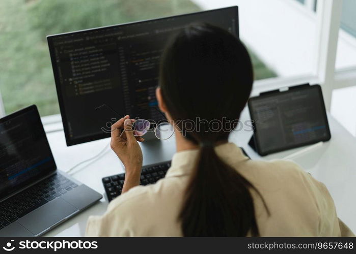 Developer programmer working to checking code on monitor while programming to developing website.
