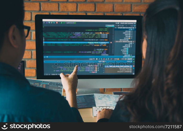 Developing programming and coding technologies working in a software engineers developing applications together in office.
