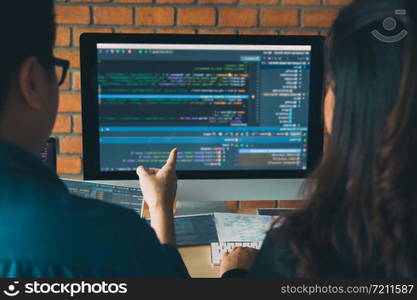 Developing programming and coding technologies working in a software engineers developing applications together in office.