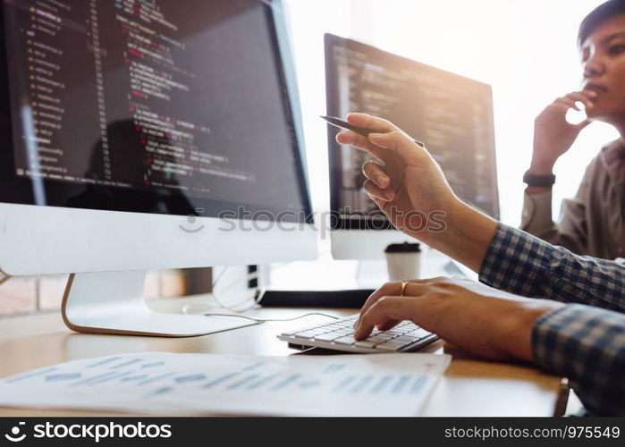 Developing programming and coding technologies working in a software engineers developing applications together in office.