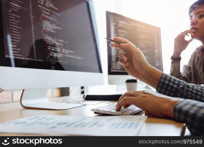Developing programming and coding technologies working in a software engineers developing applications together in office.