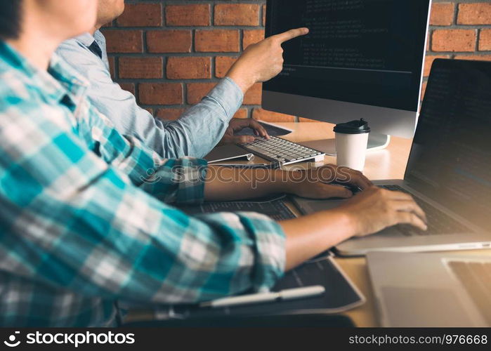 Developing programming and coding technologies working in a software engineers developing applications together in office.