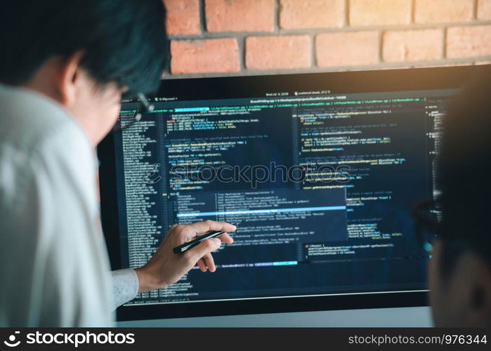 Developing programming and coding technology working in a software engineers developing applications together in office.
