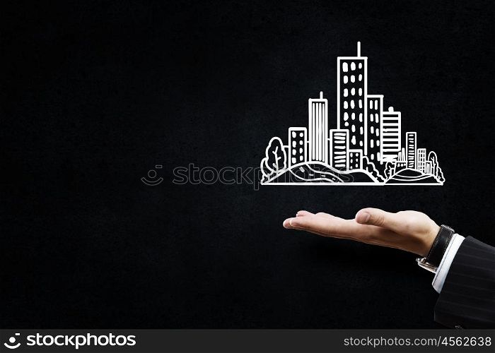 Development project. Close up of hand and drawn building model in palm
