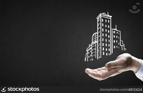 Development project. Close up of hand and drawn building model in palm
