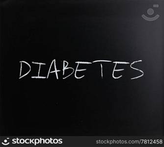 ""Diabetes" handwritten with white chalk on a blackboard."