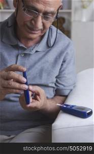 Diabetic old man testing blood sugar