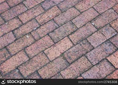 diagonal and grungy brick tile pavement surface