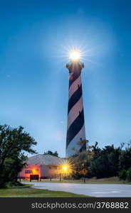 Diagonal black and white stripes mark the Cape Hatteras lighthouse at midnight